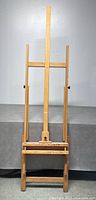 Full front view of the wooden floor easel showing its overall structure and size.