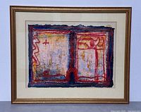 Front view of the framed mixed media artwork showing vibrant abstract composition in red, yellow, blue and black within a gold frame and white matting.