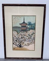 Front view of framed woodblock print showing the pagoda surrounded by cherry blossoms.