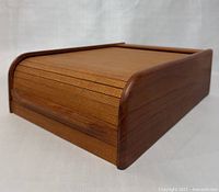 Front side view showing roll top cover and wood grain finish