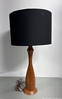 Full view of lamp with attached black fabric cylindrical shade showing overall condition and style.