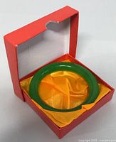 Jade bangle in open red presentation box with yellow satin lining