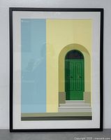 Front view of framed silkscreen print featuring green door design with blue and yellow background