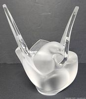 Front view of frosted glass bird-shaped vase with outstretched wings showing the detailed facial expression and overall form.