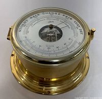 Front view of vintage Schatz brass precision barometer, showing dial with weather indicators and temperature scale