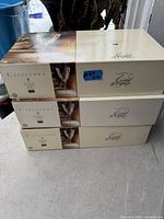 Three sealed boxes labeled Cassandra by Cristal d'Arques each with a quantity of 4 glasses inside, intact and new.