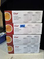 Stack of four white Master Chef 4-piece stoneware mug sets in original boxes.