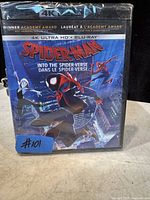 Front cover of sealed Spider-Man: Into the Spider-Verse 4K Ultra HD + Blu-ray disc showing artwork of multiple spider-characters in action poses.