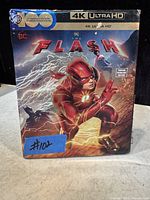 Photo of the steelbook case for The Flash 4K Ultra HD Blu-ray and DVD, showing front artwork and branding