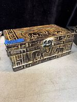 Top and side view of the vintage embossed elephant metal box showing the designs, handles, and latch