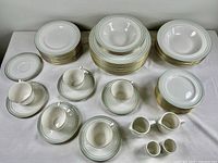 Full display of all plates, cups, saucers, and bowls showing the complete Royal Doulton Berkshire TC dinnerware set with gold and green trim details.