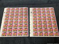 Two full sheets of 40 Elvis Presley 29 cent postage stamps each, laid flat showing colorful Elvis image.