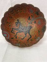 Front view of the brass cloisonne bowl showing black horse and floral designs within scalloped edges.
