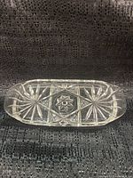Front view of the vintage Anchor Hocking Star of David butter dish showing clear glass with starburst patterns and Star of David in center.