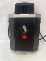Front view of the Kodak Brownie Reflex Synchro camera showing winding knob and red frame counter