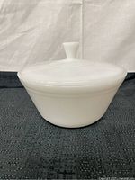 Front view of the vintage Federal Glass white milk glass covered casserole bowl with lid, showing shape and lid knob.