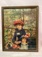 Full view of framed Renoir print "2 Sisters on the Terrace" showing two girls in colorful hats against a green leafy background.