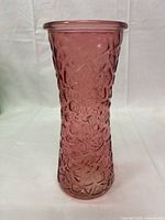 Front view of the pink diamond-patterned vase showing its overall shape and texture.