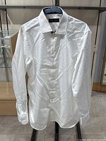 Full view of the Klaus Boehler white dress shirt hanging on a hanger, showing front, collar, cuffs, and general condition.