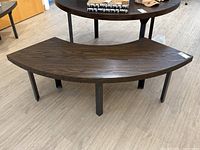 Curved oak veneer table/bench with steel legs, top surface and legs shown clearly from above