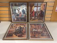 Four framed vintage tailoring prints displayed on floor against a wood-paneled wall, showing tailoring scenes and minor frame scratches.