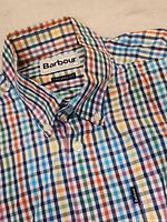 Close-up photo of Barbour label and button-down collar showing the colorful checkered pattern in blue, green, yellow, and orange tones.