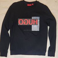 Full black sweatshirt with front graphic print showing 'HUGO' and textured gray rectangle on the front