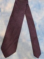 Full view of the Hugo Boss necktie showing the overall purple patterned design on dark base fabric.