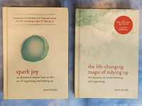 Front covers of 'Spark Joy' and 'The Life-Changing Magic of Tidying Up' showing title and author names.