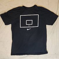 Full front view of the black Nike T-shirt, showing the basketball backboard graphic and Nike swoosh beneath it.