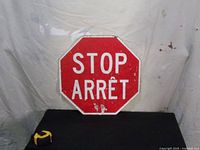 Photo showing the red octagonal aluminum stop sign with 'STOP / ARRÊT' text in English and French.