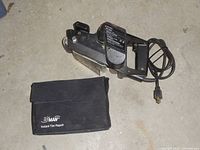 Black & Decker electric belt sander with power cord placed on the floor