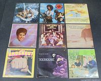 Front view of 9 vinyl records showcasing album cover art including Boney M and Tom Jones.
