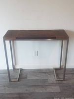 Front view of hallway table showing reclaimed barnboard top and stainless steel legs.