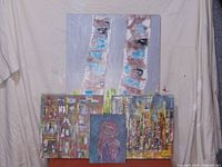Group photo showing four original acrylic paintings on canvas including two birch trees, two abstract city-building themed, and one portrait painting.