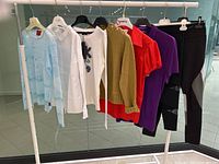 View of entire lot hanging on rack including tops, dress, and leggings