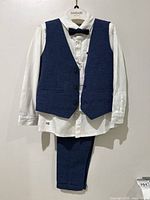 Full view of Mayoral boy's formal wear set size 36M on hanger, shows white dress shirt, blue vest, blue pants, and bow tie.