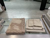 Overview of both folded tablecloths and napkins on glass surface