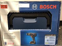 Front of original boxed Bosch cordless drill kit showing handle and image of drill.