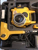 DeWalt laser level unit with attached 18V battery seen in open carrying case with foam inserts.
