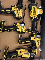 Overview of five DeWalt 20V MAX cordless tools laid out in cardboard box