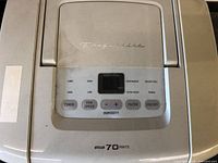 Close-up of top control panel showing Frigidaire branding, control buttons, and digital humidity display.