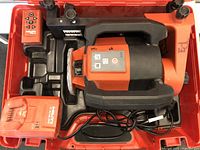 Laser level, remote, charger and battery in red hard case, all items visible