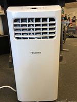 Front view of Hisense portable air conditioner showing front vent grille and top control panel.