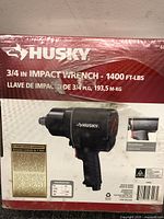 Photo of front of Husky impact wrench box showing product name, image of impact wrench, torque specification, and warranty info