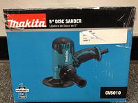 Front of the Makita GV5010 5-inch disc sander box showing the product image and branding.