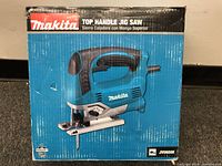 Image showing original box of Makita top handle jig saw in blue and black with product image on front and model number JV0600K.