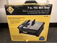 Front view of the QEP 7-inch Tile Wet Saw box showing product image and description in English and Spanish.