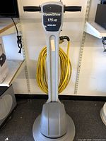 Front view of the SpeedShine 175 HD Nobles floor buffer showing handle, branding, and coiled yellow power cable.