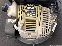Close-up of Ryobi BP42 gasoline engine unit showing model sticker and start/run lever.
